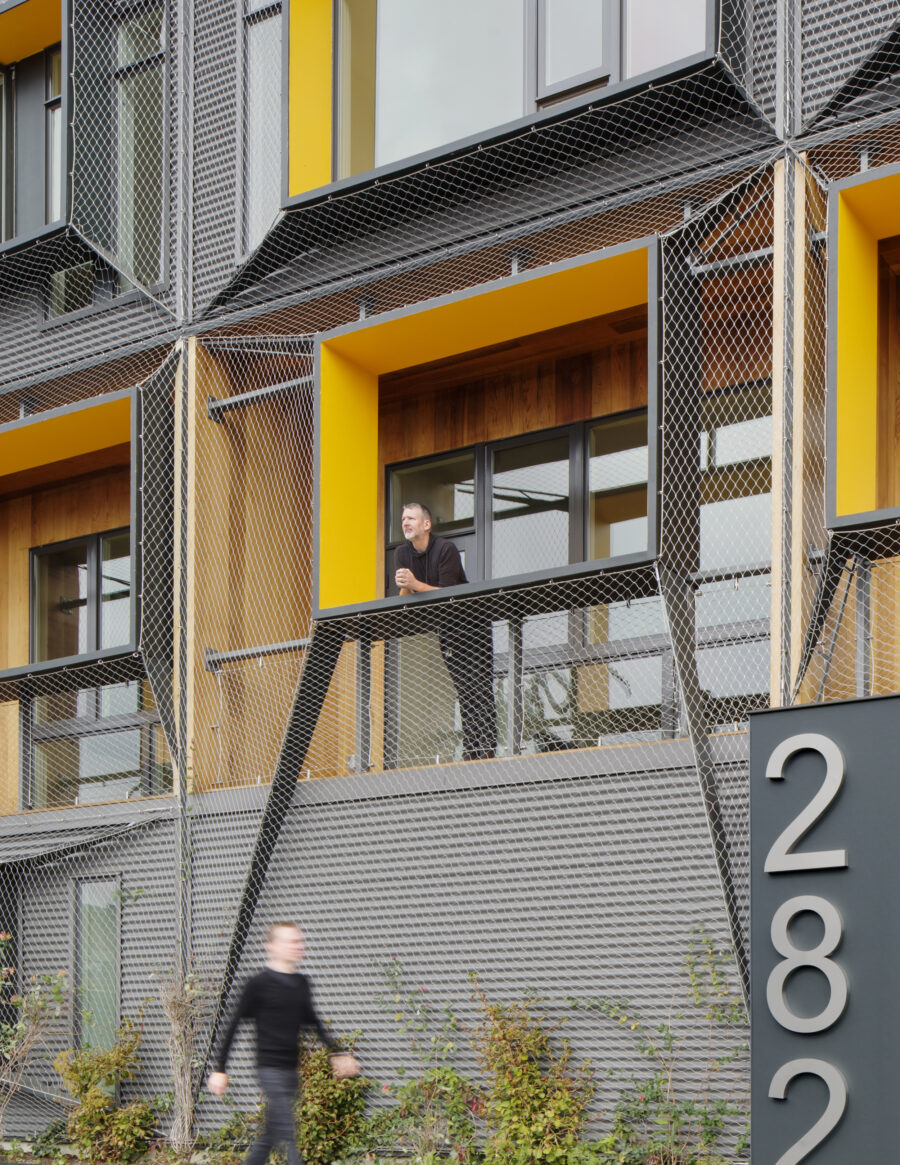 shrink wrap mesh facade recessed balcony cedar