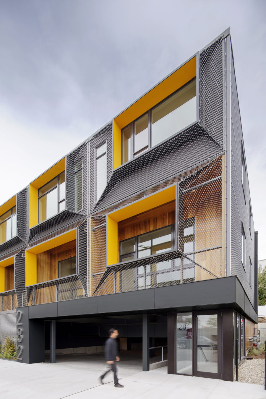 shrink wrap mesh facade cedar balconies