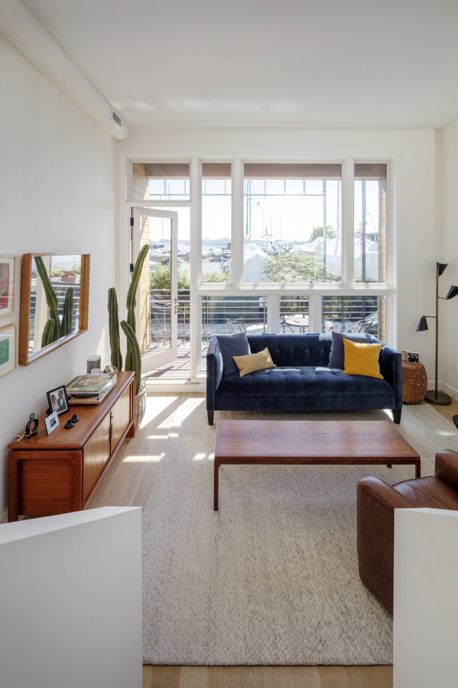 living room interior view towards waterfront with mid century furniture