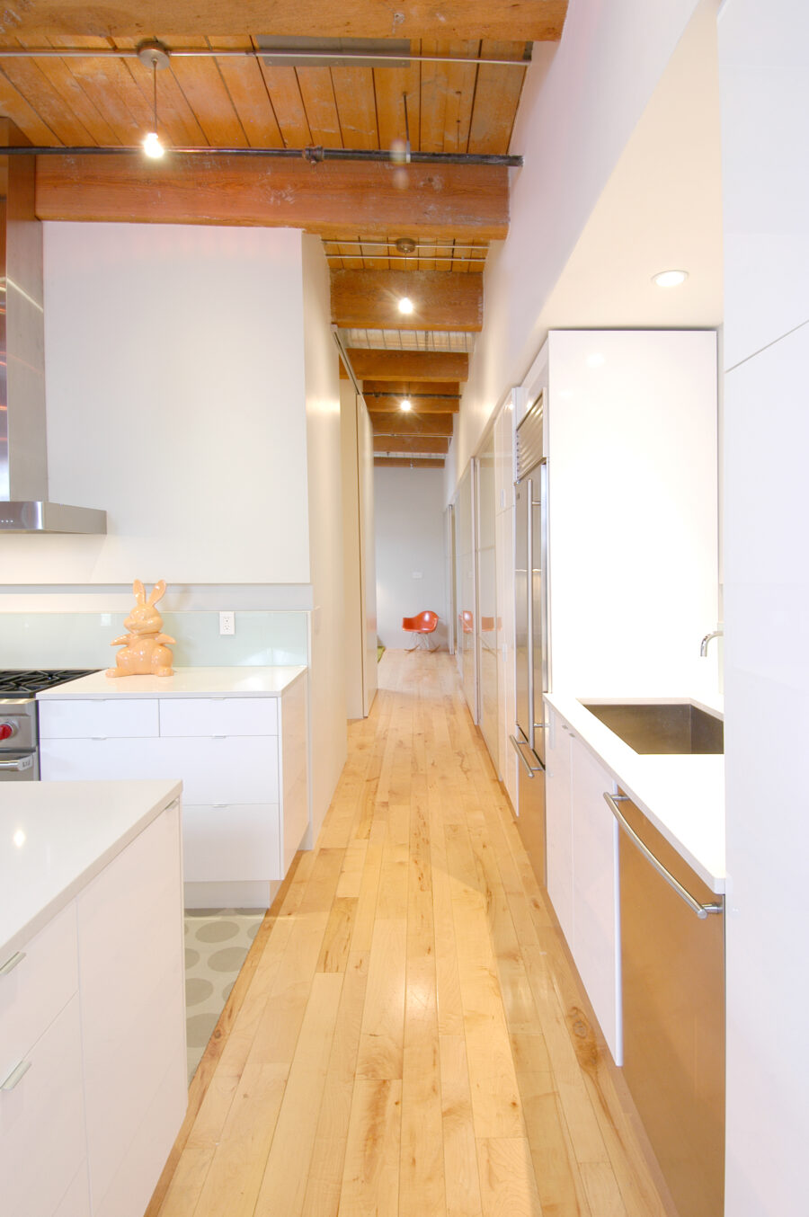 corridor through white kitchen