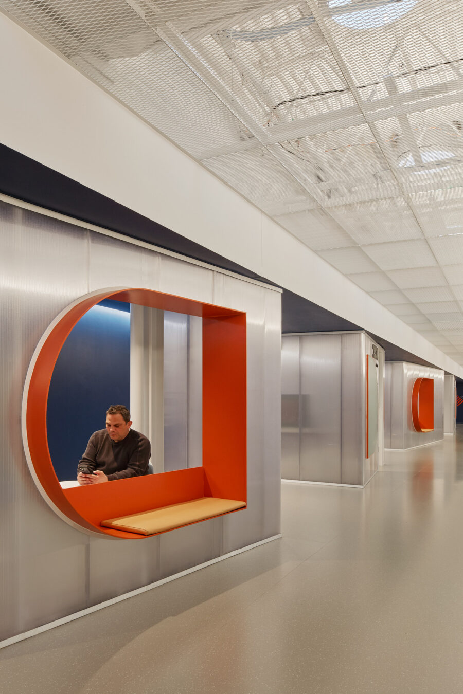 Boston EMS corridor translucent pods mesh ceiling