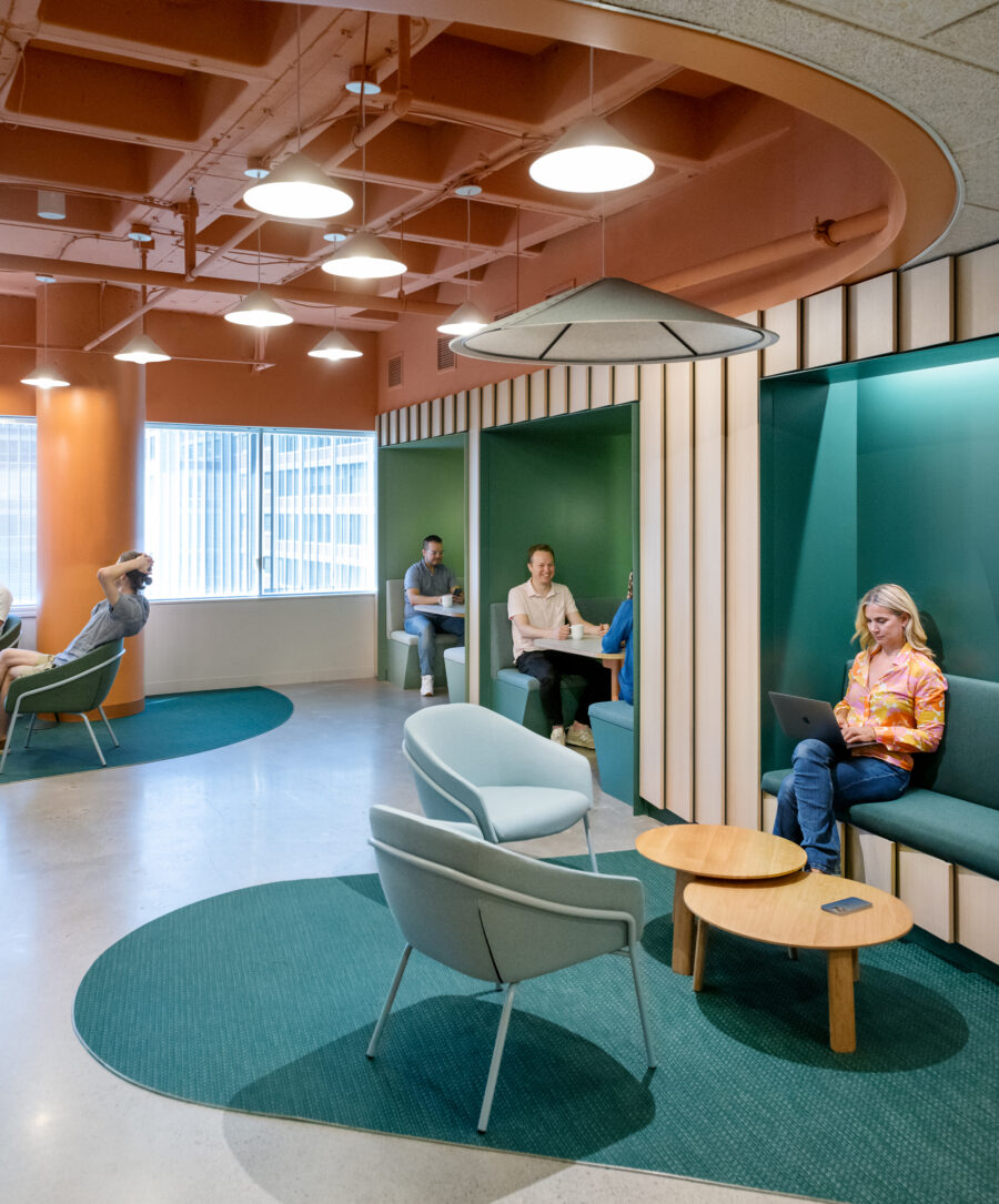 Lounge with lapped wood panels and colorful seating nooks