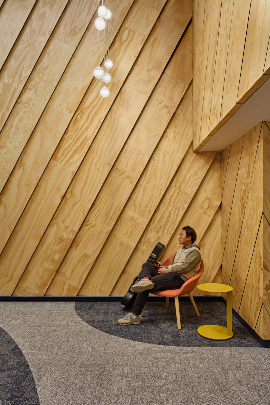 slanted wood clad wall with seating lounge